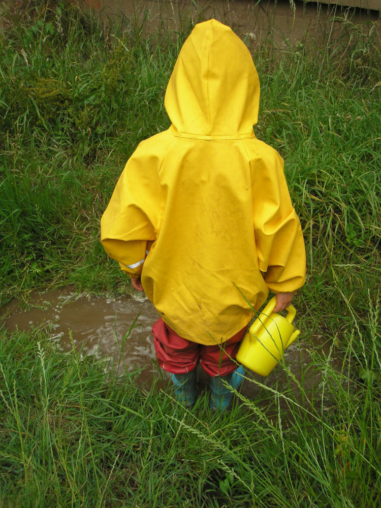 Child with yellow coat